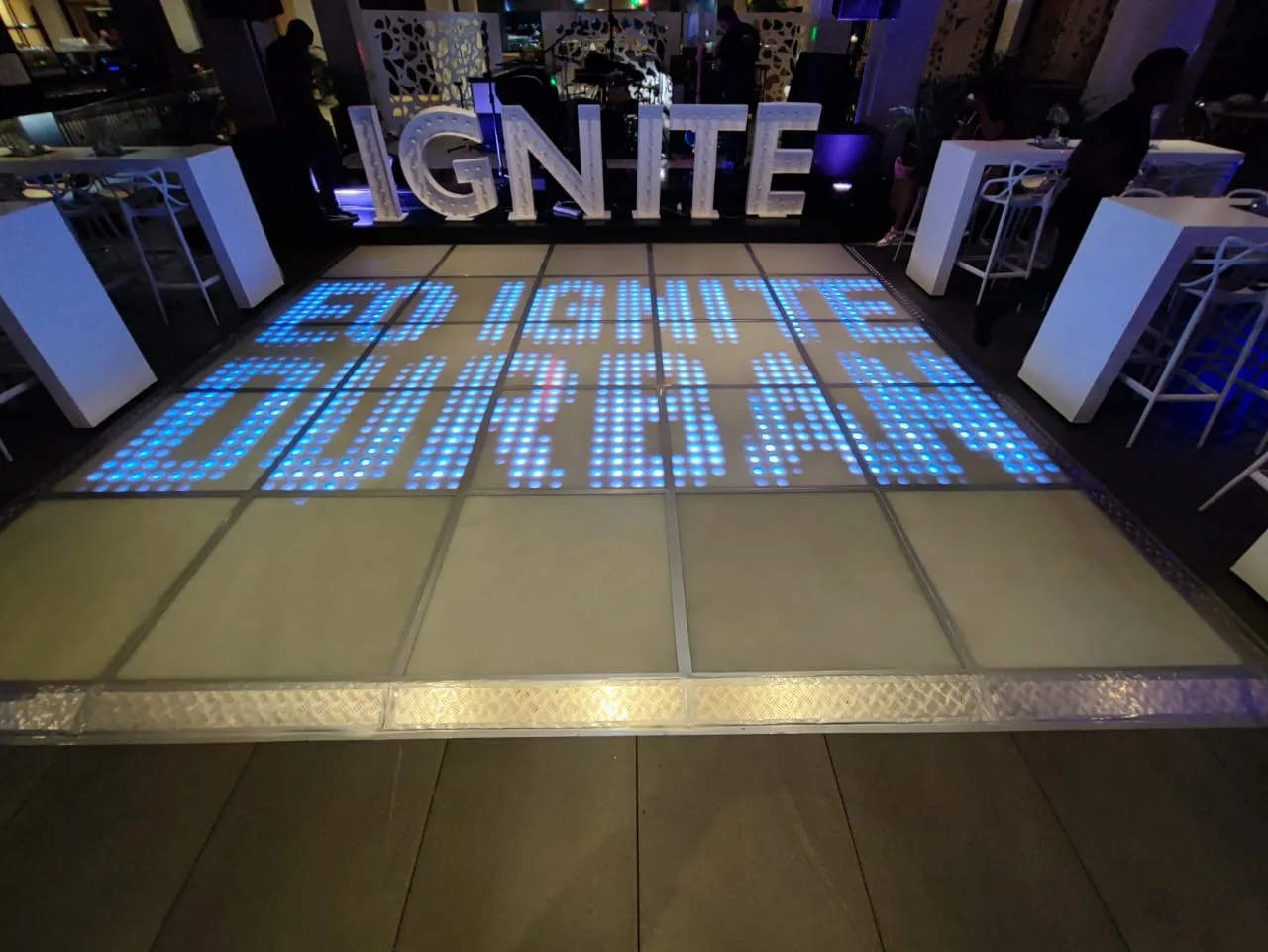 Custom IGNITE text displayed across an LED floor