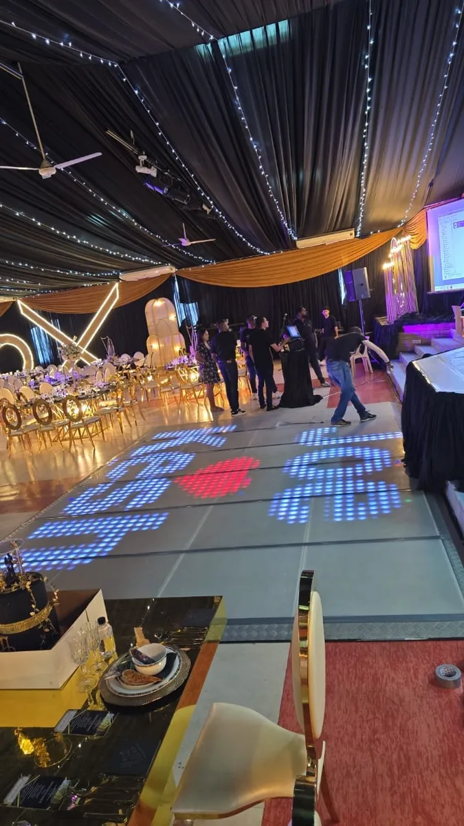White LED dance floor showing heart graphics at a wedding